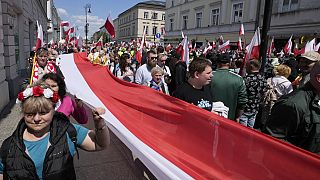 Supporters of conservative presidential candidate Karol Nawrocki take part in a march one week ahead of a decisive election in Warsaw Poland, Sunday, May 25, 2025. 